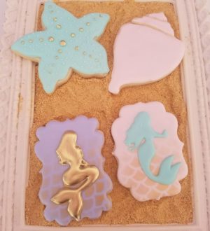 Royal icing cookies in a box, perfect for a Quinceanera celebration