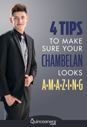 A man in a tuxedo suit standing with his hands in his pockets at a Quinceanera celebration