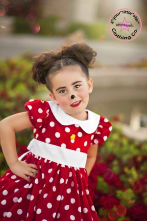 Quinceanera image of a little girl wearing a polka dot Minnie Mouse costume.