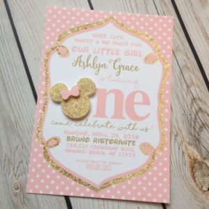 A Quinceanera invitation featuring a heart-shaped design made of paper. The invitation is decorated with a pink and gold Minnie Mouse theme.