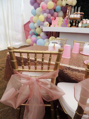 Quinceanera party, a chair with a pink bow tied to it