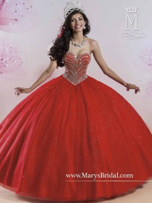 A woman in a red ball gown posing for a picture in vestidos rojos de 16 Quinceañera dresses.