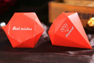 An image of orange STX GLB.1800 UTIL. GR EUR, with a couple of red boxes sitting on top of a table at a Quinceanera celebration.
