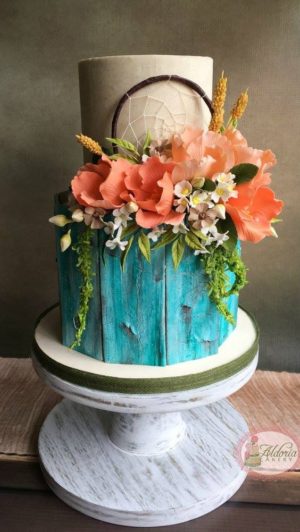 A Quinceanera cake, a three-tiered cake with flowers on top, featuring a southwestern design