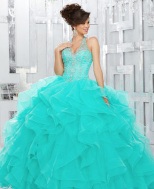 Quinceanera: A woman in a turquoise dress posing for a picture in a gown