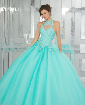 A woman in a blue Quinceañera gown posing for a picture