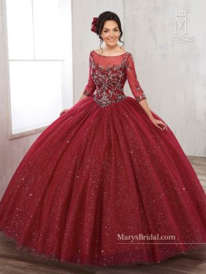 A woman in a red Quinceañera ball gown posing for a picture