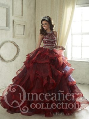 Two piece burgundy Quinceañera dresses, a woman in a red dress posing for a picture