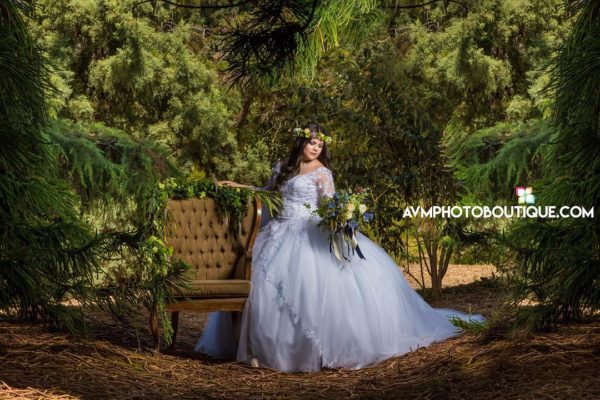 Quinceanera gown photo shoot, a woman in a Quinceanera dress sitting on a bench