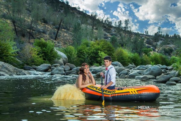 A Quinceanera couple enjoying a scenic river ride on a raft