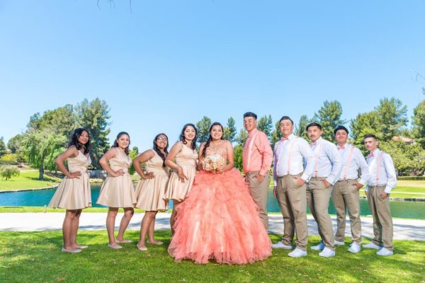 Quinceañera dresses, a group of people posing for a picture