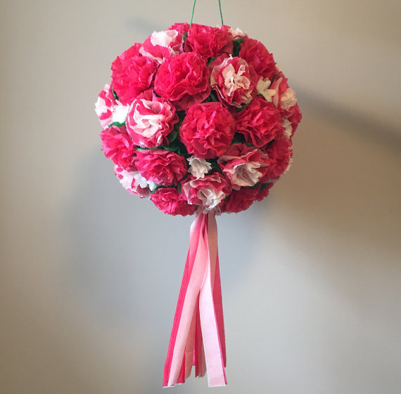 Quinceañera floral design, a bouquet of pink and white flowers hanging from a wall