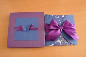 A Quinceanera themed gift create, featuring a purple and blue card adorned with a purple bow