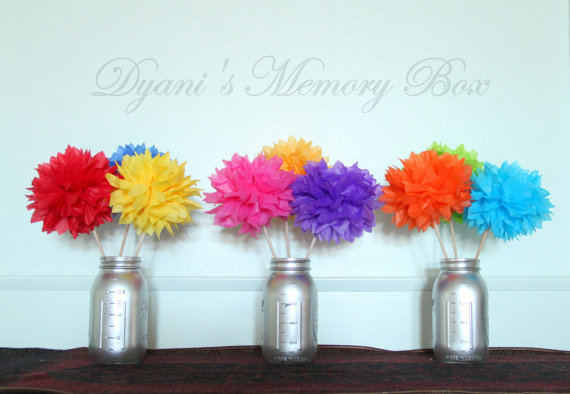 A row of vases with floral arrangements of cut flowers for a Quinceanera