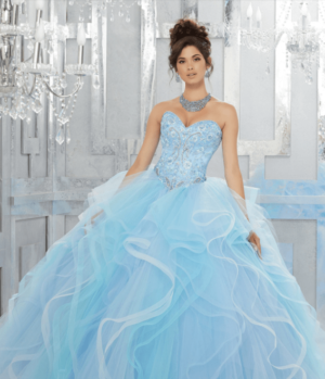Quinceanera gown, a woman in a blue dress posing for a picture