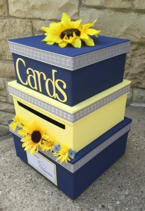 Three stacked boxes with sunflowers on top, perfect for a Quinceanera celebration