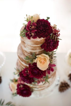 A Quinceanera event featuring peach colors. The image shows a three-tiered cake with flowers on a table.