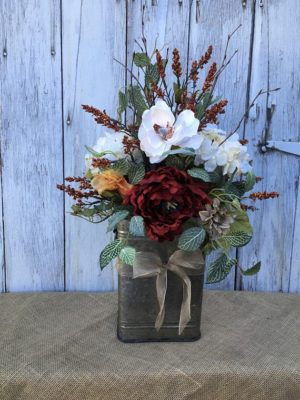Quinceanera: A fall-themed Quinceañera featuring a vase filled with flowers on top of a table