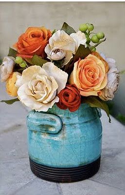 A beautiful arrangement of cut flowers in a blue vase on a table, adding color and vibrancy to a Quinceanera celebration.
