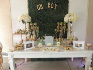 A table with a bunch of desserts on it for a Quinceanera celebration