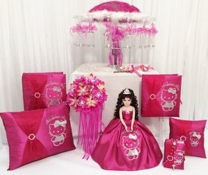 Quinceañera, a hello kitty doll surrounded by pink pillows