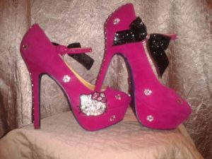 Quinceañera: A pair of pink high heels with a bow.