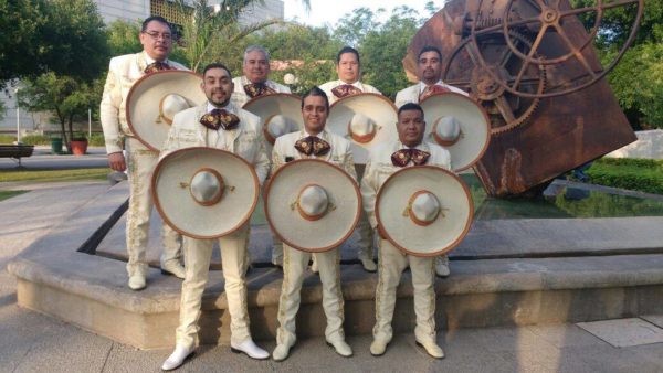 A group of men standing next to each other, with a bass drum