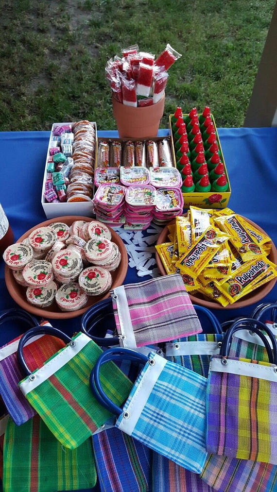 Quinceañera, a table topped with lots of food on top of a blue table cloth in a Mexican quinceanera theme