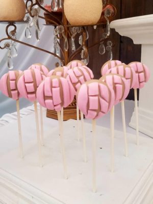 Quinceanera charro theme dessert table Party, a bunch of pink lollipops sitting on top of a table