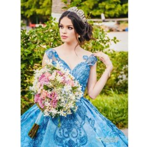 A woman in a blue Quinceanera dress holding a bouquet