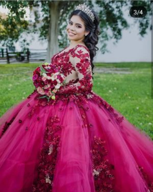 A woman in a red gown Quinceañera posing for a picture