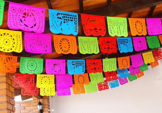 Quinceanera: Hispanic decoration party with brightly colored paper decorations hanging from a ceiling