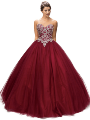 Quinceanera gown - A woman in a red ball gown standing in front of a white background