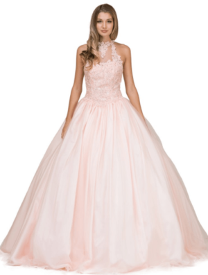 A woman in a pink ball gown posing for a picture at a Quinceanera