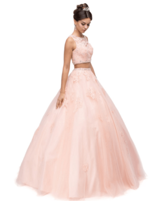 A woman in a pink Quinceanera ball gown posing for a picture