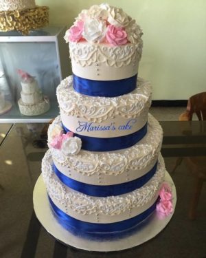 Quinceanera cake, a three tiered cake with a pink rose on top