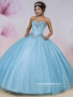 A woman in a blue dress posing for a picture in gown Quinceañera dresses