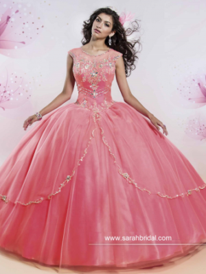 Quinceanera gown: A woman in a pink dress posing for a picture.