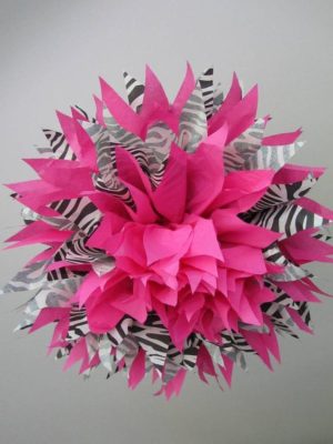 A beautiful Quinceanera decoration featuring a cut flower made of pink and black paper with zebra stripes