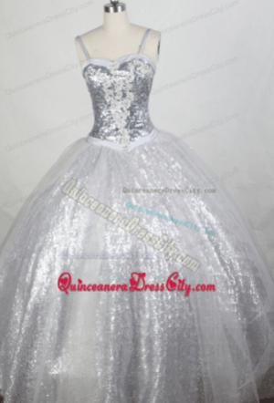 A beautiful Quinceanera gown dress, featuring a white color adorned with silver sequins.