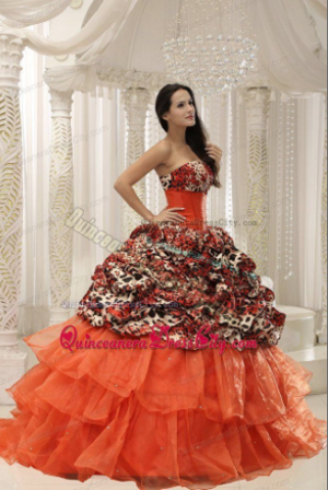 Quinceanera Gown, a woman in an orange dress posing for a picture