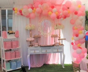 A Quinceañera birthday party with pink and yellow balloons