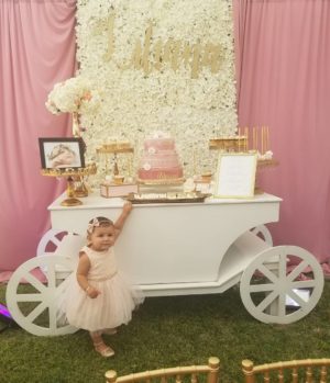 Quinceanera ceremony supply, a little girl standing in front of a cake cart