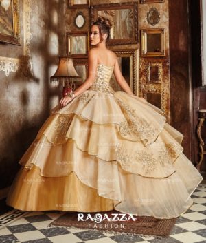 A woman in a dress from the Ragazza collection Quinceañera dresses standing in a room.