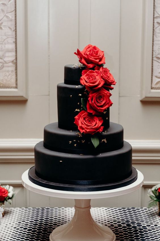 Black and red Quinceanera cake. A three tiered red velvet cake with red roses on top.