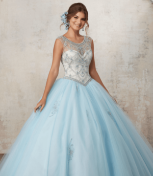 A woman in a blue Quinceañera gown posing for a picture