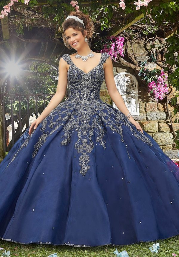 quinceanera vizcaya Quinceañera dresses, a woman in a blue ball gown standing in a garden
