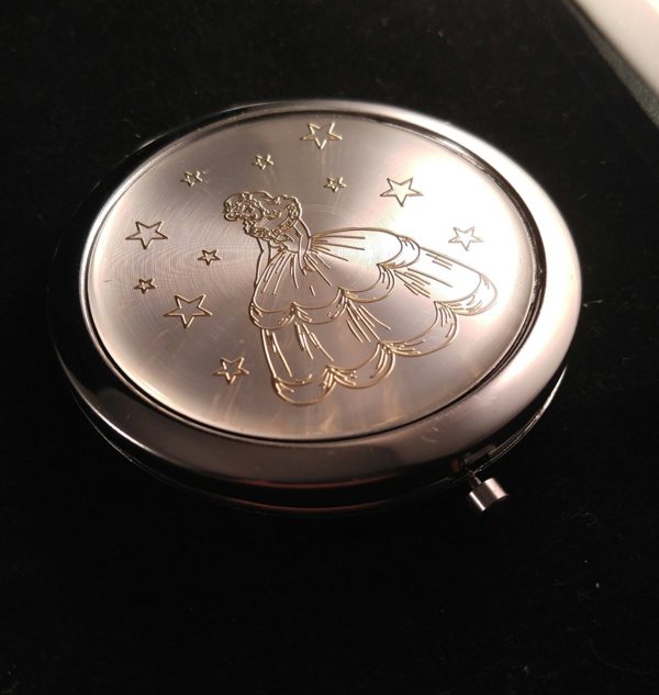 A Quinceanera themed item from Amazon.com, featuring a compact mirror with a picture of a fairy on it