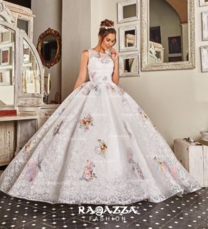A woman in a gown and Quinceañera dress standing in a room
