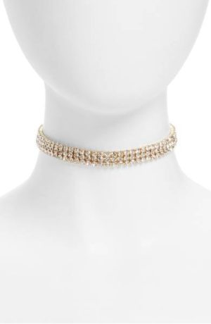 A gold choke necklace displayed on a white mannequin head for Quinceanera